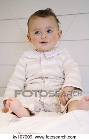 Baby smiling sitting in interior View Large Photo Image Stock Photo - Baby smiling sitting in interior. Fotosearch
