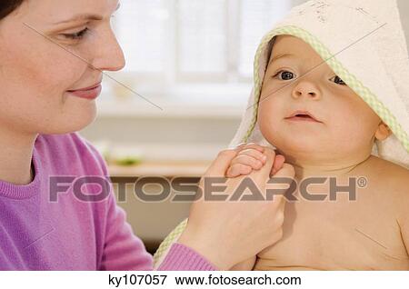 Mother and baby with towel on his head View Large Photo Image Stock Photo - Mother and baby with towel on his head. Fotosearch