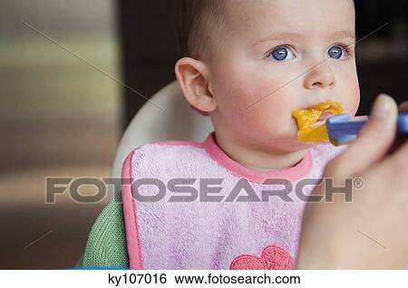 Mother feeding her Baby, close up View Large Photo Image Stock Photograph - Mother feeding her Baby, close up. Fotosearch