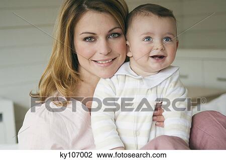Portrait of a Woman and baby smiling, interior View Large Photo Image Stock Image - Portrait of a Woman and baby smiling, interior. Fotosearch