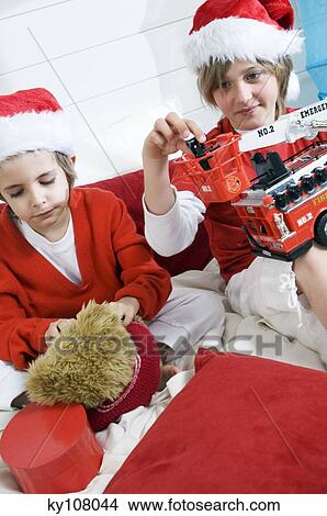 2 boys disguised as Santa Claus playing View Large Photo Image Picture - 2 boys disguised as Santa Claus playing. Fotosearch