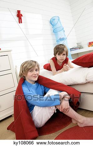 2 boys in bedroom, looking at the camera View Large Photo Image Stock Photograph - 2 boys in bedroom, looking at the camera. Fotosearch