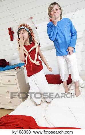 2 boys playing indians standing onbed View Large Photo Image Stock Photo - 2 boys playing indians standing onbed. Fotosearch