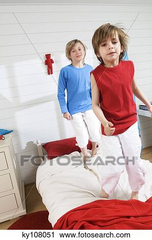 2 boys standing on bed View Large Photo Image Stock Image - 2 boys standing on bed. Fotosearch