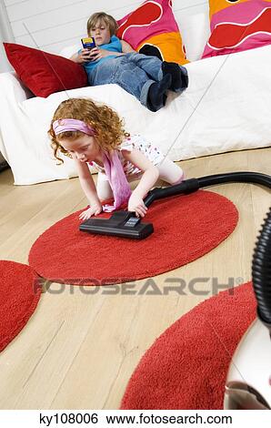 2 children at home, little girl vacuuming, little boy sitting on a sofa View Large Photo Image Stock Photograph - 2 children at home, little girl vacuuming, little boy sitting on a sofa. Fotosearch
