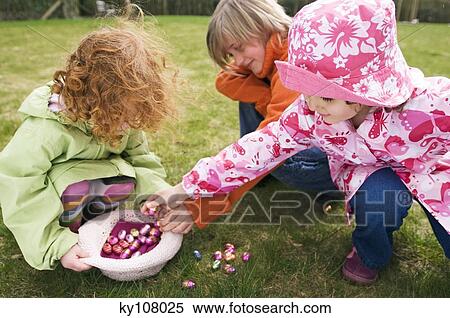 3 children in garden with Easter eggs View Large Photo Image Stock Photography - 3 children in garden with Easter eggs. Fotosearch