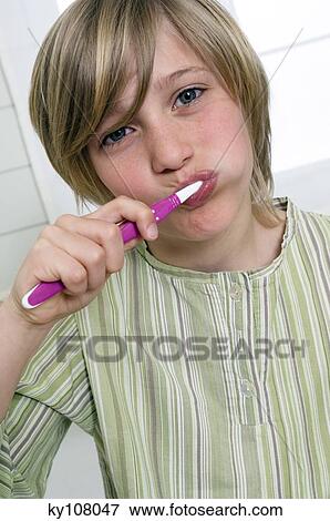 Stock Photo - Boy brushing his teeth. Fotosearch
