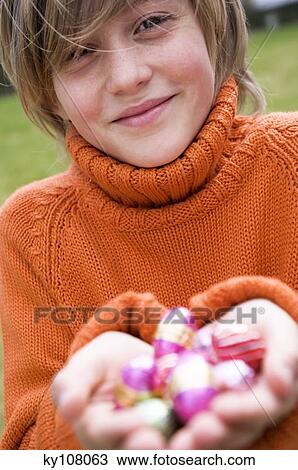 Stock Image - Boy holding Easter eggs. Fotosearch