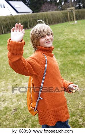 Boy in garden saying goodbye View Large Photo Image Stock Photo - Boy in garden saying goodbye. Fotosearch