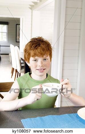 Little boy at breakfast table View Large Photo Image Stock Photo - Little boy at breakfast table. Fotosearch