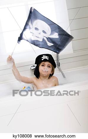 Little boy in bath holding pirate flag View Large Photo Image Stock Photo - Little boy in bath holding pirate flag. Fotosearch