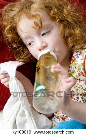 Little girl and baby's bottle View Large Photo Image Stock Photo - Little girl and baby's bottle. Fotosearch