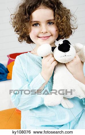 Little girl holding stuffed dog View Large Photo Image Stock Photograph - Little girl holding stuffed dog. Fotosearch
