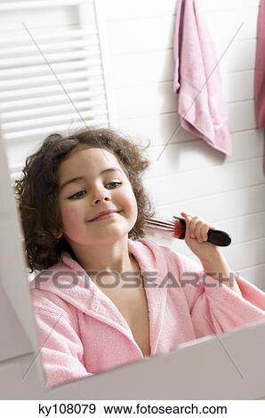 Little girl in bathroom brushing her hair View Large Photo Image Stock Photo - Little girl in bathroom brushing her hair. Fotosearch