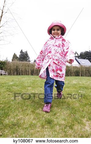 Stock Photo - Little girl in garden. Fotosearch