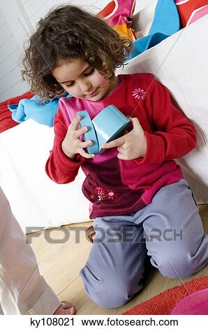 Little girl playing indoors View Large Photo Image Stock Image - Little girl playing indoors. Fotosearch