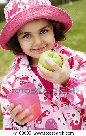 Little girl with apple and glass View Large Photo Image Stock Photo - Little girl with apple and glass. Fotosearch