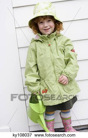 Little girl with watering can View Large Photo Image Stock Photo - Little girl with watering can. Fotosearch