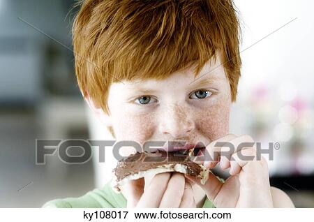 Portrait of a little boy eating a slice of bread and chocolate View Large Photo Image Stock Photo - Portrait of a little boy eating a slice of bread and chocolate. Fotosearch