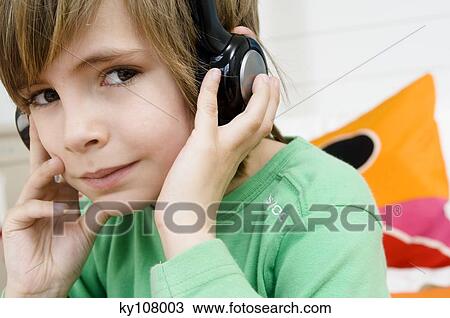 Stock Image - Portrait of a little boy with headphones. Fotosearch