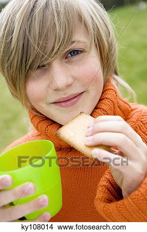 Portrait of a young boy with biscuit and glass View Large Photo Image Picture - Portrait of a young boy with biscuit and glass. Fotosearch