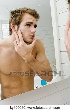 Barechested man in front of bathroom mirror View Large Photo Image Stock Image - Barechested man in front of bathroom mirror. Fotosearch