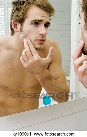 Barechested man in front of bathroom mirror View Large Photo Image Stock Image - Barechested man in front of bathroom mirror. Fotosearch