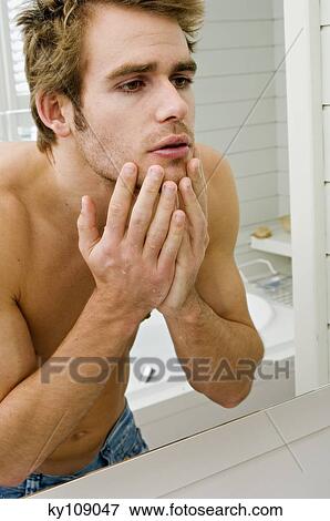 Barechested man in front of bathroom mirror View Large Photo Image Stock Photo - Barechested man in front of bathroom mirror. Fotosearch