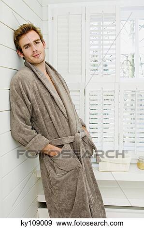 Young man in bathrobe, leaning against wall, looking at the camera View Large Photo Image Stock Photo - Young man in bathrobe, leaning against wall, looking at the camera. Fotosearch
