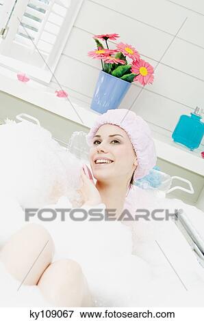 Young smiling woman having a bath View Large Photo Image Stock Photo - Young smiling woman having a bath. Fotosearch