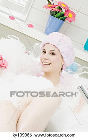 Young woman having a bath, smiling for the camera View Large Photo Image Stock Photography - Young woman having a bath, smiling for the camera. Fotosearch