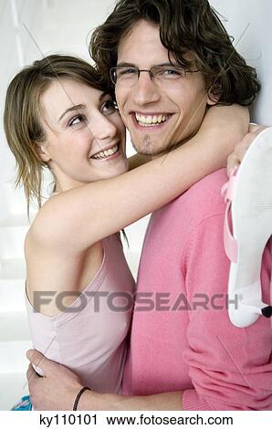 Couple embracing, smiling for the camera View Large Photo Image Stock Image - Couple embracing, smiling for the camera. Fotosearch