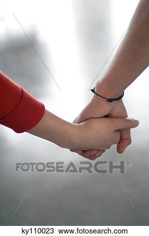 Couple holding hands, close-up View Large Photo Image Stock Image - Couple holding hands, close-up. Fotosearch