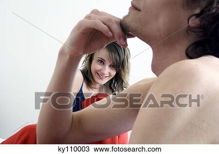 Couple in bed, barechested man thinking, smiling woman in the background View Large Photo Image Stock Image - Couple in bed, barechested man thinking, smiling woman in the background. Fotosearch