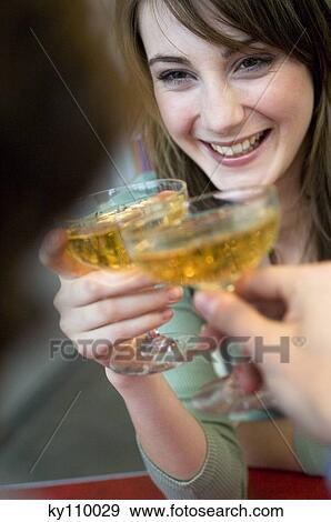 Smiling couple clinking champagne glasses, close-up View Large Photo Image Stock Photo - Smiling couple clinking champagne glasses, close-up. Fotosearch