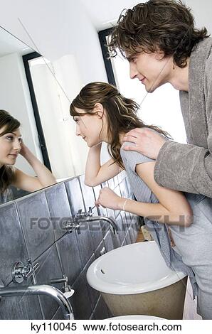 Smiling couple in front of bathroom mirror View Large Photo Image Stock Photography - Smiling couple in front of bathroom mirror. Fotosearch