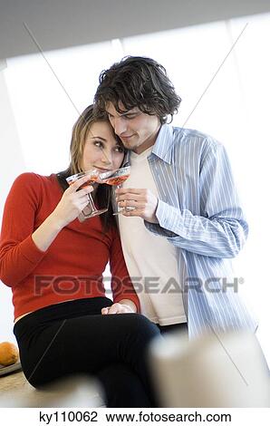 Young couple clinking champagne glasses View Large Photo Image Stock Image - Young couple clinking champagne glasses. Fotosearch