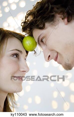 Young couple face to face, looking at each other View Large Photo Image Stock Image - Young couple face to face, looking at each other. Fotosearch