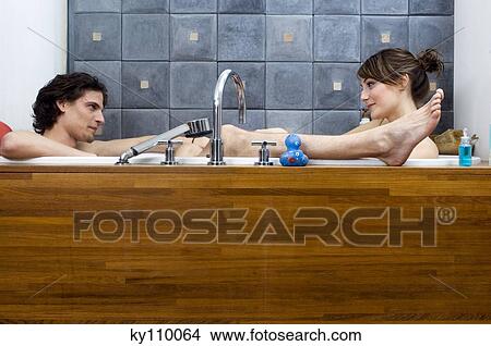 Young couple having a bath, looking at each other View Large Photo Image Picture - Young couple having a bath, looking at each other. Fotosearch