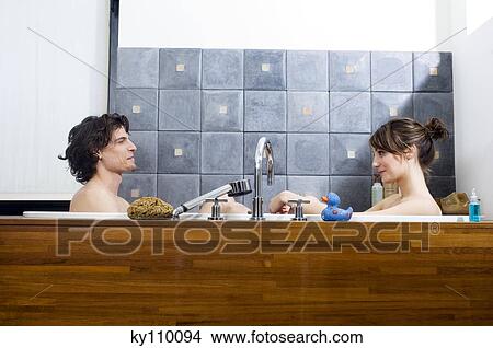 Picture - Young couple having a bath, looking at each other. Fotosearch