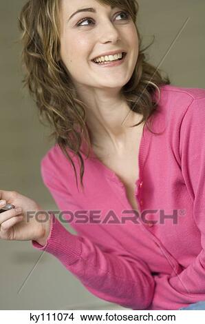 Portrait of a smiling woman looking away View Large Photo Image Picture - Portrait of a smiling woman looking away. Fotosearch