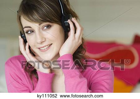 Portrait of a woman wearing headphones View Large Photo Image Stock Image - Portrait of a woman wearing headphones. Fotosearch