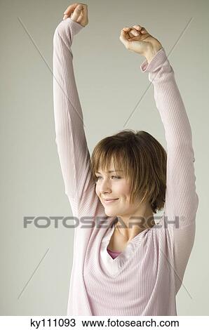Portrait of a young woman stretching View Large Photo Image Stock Image - Portrait of a young woman stretching. Fotosearch