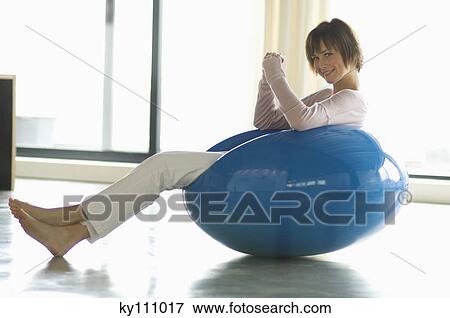 Young smiling woman resting in blue armchair View Large Photo Image Stock Photo - Young smiling woman resting in blue armchair. Fotosearch