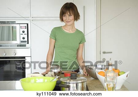 Young woman cooking View Large Photo Image Stock Photo - Young woman cooking. Fotosearch