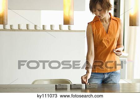 Young woman lighting candles View Large Photo Image Stock Image - Young woman lighting candles. Fotosearch