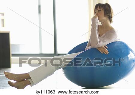 Young woman resting in blue armchair View Large Photo Image Stock Image - Young woman resting in blue armchair. Fotosearch