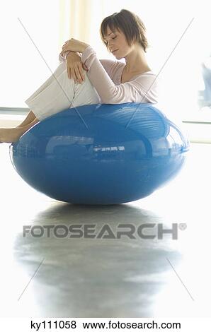 Young woman resting in blue armchair View Large Photo Image Stock Photo - Young woman resting in blue armchair. Fotosearch