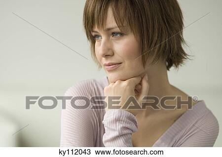 Stock Image - Portrait of a young thinking woman. Fotosearch