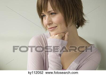 Stock Image - Portrait of a young thinking woman. Fotosearch